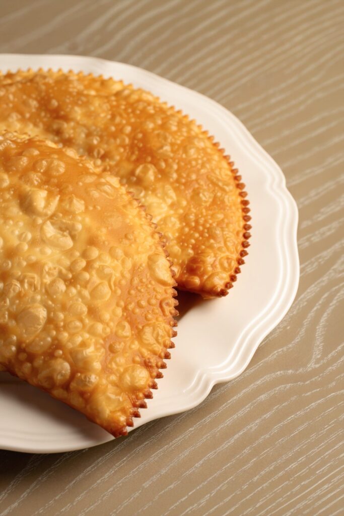 Two chebureki on a white plate
