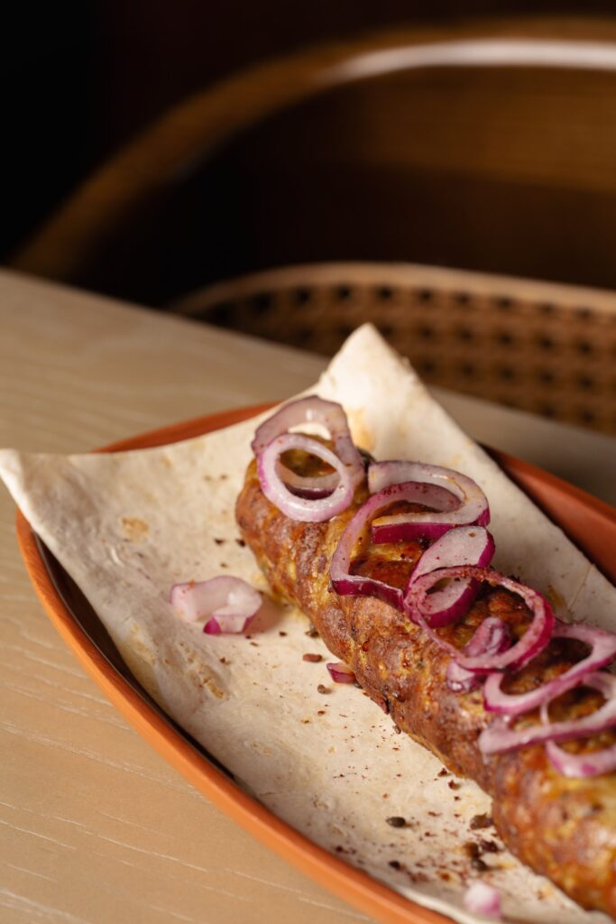 Kebab on lavash on a terracotta plate